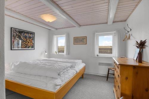 a bedroom with a large bed and two windows at 526-Lemvig-Rubyvej-21 in Lemvig