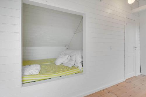 a white room with a bed in a wall at 526-Lemvig-Rubyvej-21 in Lemvig
