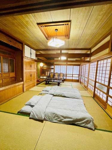 a large room with a bed in the middle at 与那国島一棟貸切宿はいぬきち in Yonaguni