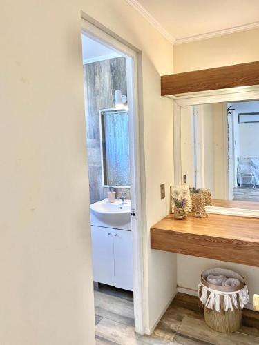 a bathroom with a sink and a mirror at Apart hotel Entre Ríos ruta 5 Talca in Talca