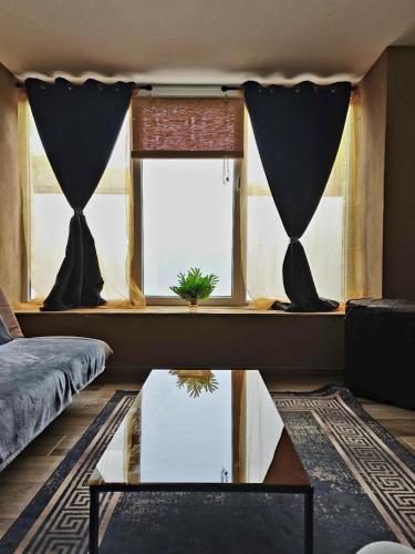 a living room with a glass table and a window at Forest Hideout in Vielsalm