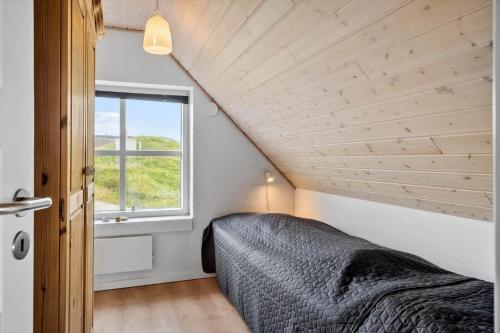 a bedroom with a bed and a window at VK233-Harboore-Doblervej-83 in Harboør