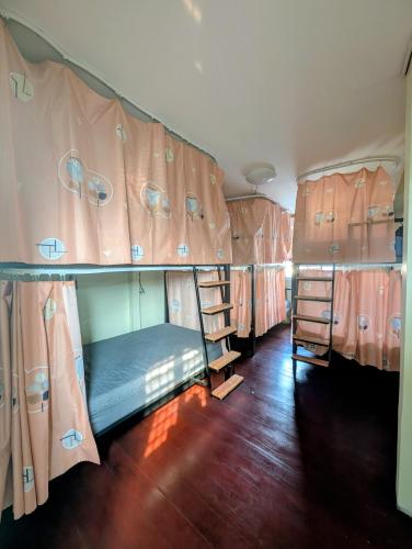 a group of three bunk beds in a room at Happy Hope Khao San in Bangkok