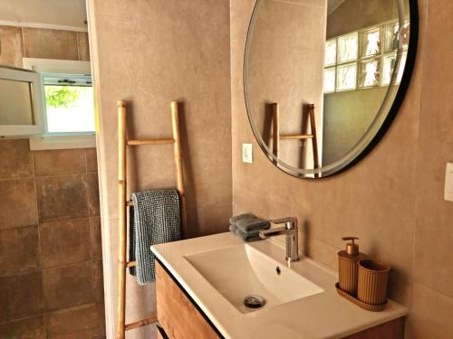 a bathroom with a sink and a mirror at Casa La Jolla B&B in Cómpeta