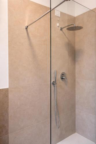 a shower with a glass door in a bathroom at Villa Magnolia in Vicenza