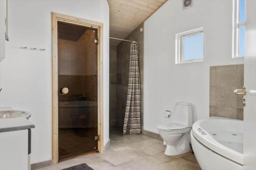 a bathroom with a toilet and a tub and a sink at 519-Lemvig-Gaskaervej-95-h in Lemvig