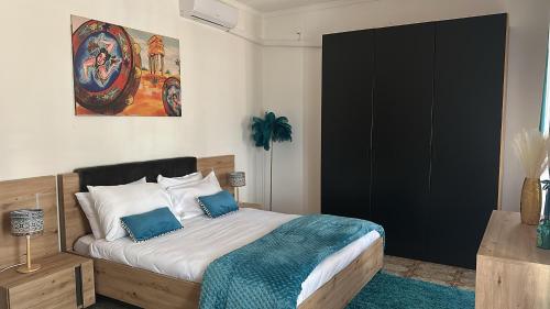 a bedroom with a bed with blue and white pillows at Addaura Paradise House in Palermo