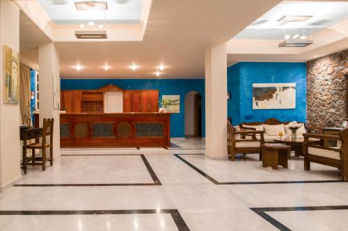 a lobby with blue walls and a dining room at Antinea Suites Hotel & Spa in Kamari