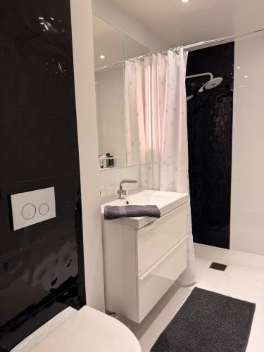 a white bathroom with a sink and a toilet at Villa Daga in Vidsel