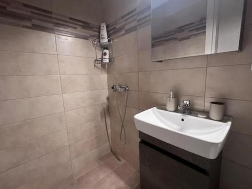 a bathroom with a sink and a shower at Velvet studios Ioanna in Naousa