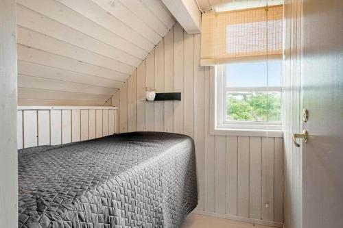 a bedroom with a bed in a room with a window at 529-Lemvig-Lokkevej-61-A in Lemvig