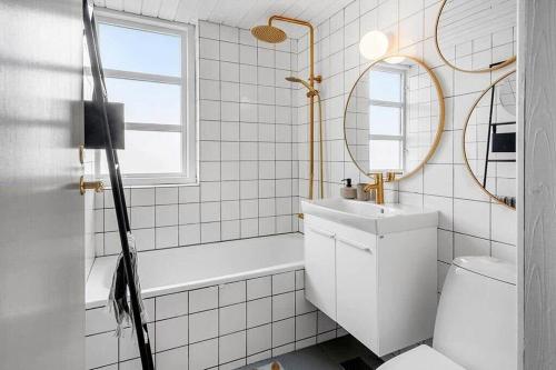 a bathroom with a toilet and a sink and a mirror at 529-Lemvig-Lokkevej-61-A in Lemvig