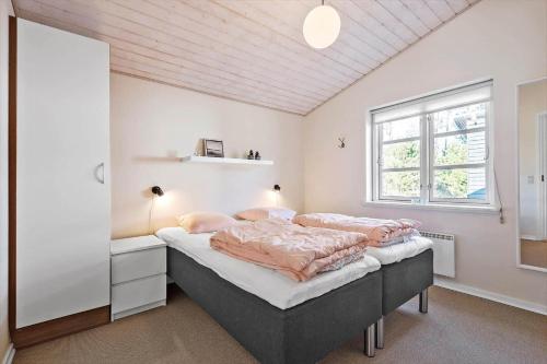 a bedroom with a bed and a window at 0379-Romo-Stormengevej-14 in Høm