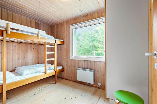 a bedroom with two bunk beds and a window at 0127-Romo-Umanaksvej-4 in Høm