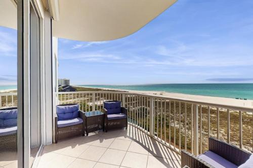 a balcony with chairs and a view of the beach at Spanish Key 304 in Perdido Key