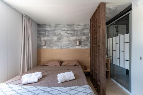 a bedroom with a bed with two towels on it at Domaine de Miremer in La Garde-Freinet