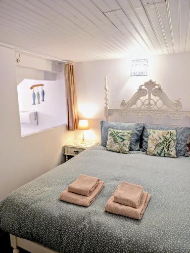a bedroom with a bed with two towels on it at Charming Portuguese style apartment, for rent "Vida à Portuguesa", "Fruta or Polvo" Alojamento Local in Portimão