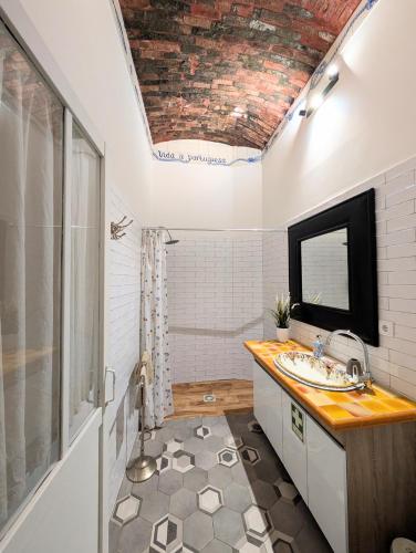 a bathroom with a sink and a mirror at Charming Portuguese style apartment, for rent "Vida à Portuguesa", "Fruta or Polvo" Alojamento Local in Portimão