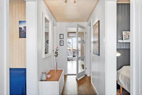 a room with a hallway with a bed and a table at 0421-Romo-Vestergade-3-Ap-34 in Høm