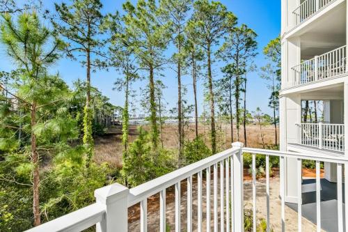 a view from the balcony of a house with trees at Lasata #3112 in Destin