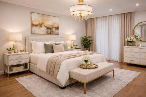 a bedroom with a large bed and a chandelier at Grand Properties in Atlanta