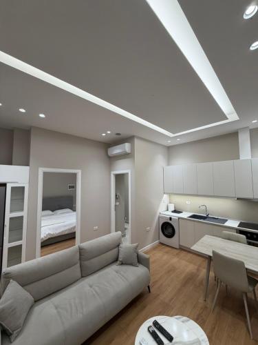 a living room with a couch and a bed at Apartment 27 in Elbasan