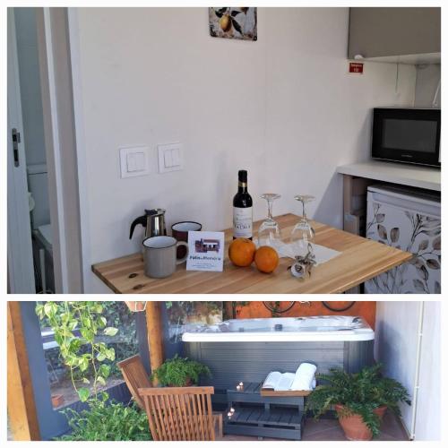 a kitchen with a table with a bottle of wine at Páteo da Memória Casa do Pintor in Quinta do Anjo