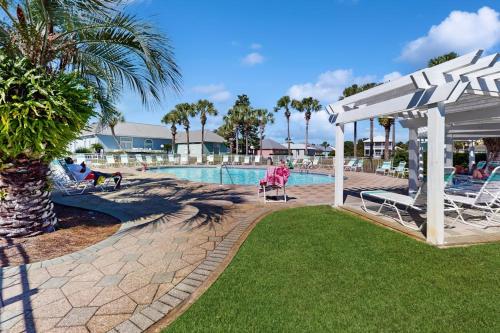a pool at a resort with chairs and a pavilion at Maravilla 1114 in Destin