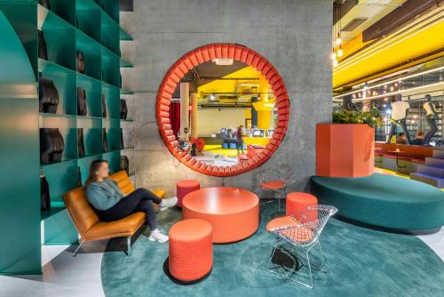 a man sitting in a chair in front of a mirror at The Social Hub Vienna in Vienna