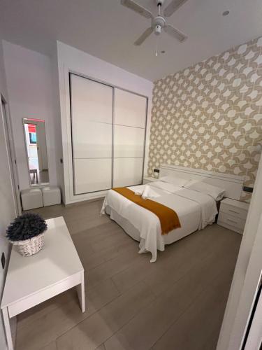 a bedroom with a white bed and a large window at Rota Beach Loft in Rota
