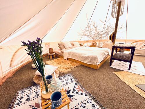 a room with a tent with a bed and flowers at Osada na hůrce in Hustopeče