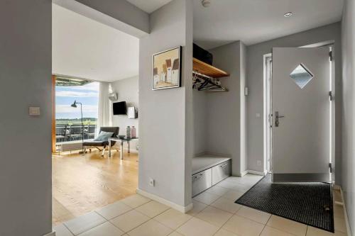 a living room with a hallway with a door and a table at 0344-Romo-Vestergade-331 in Høm