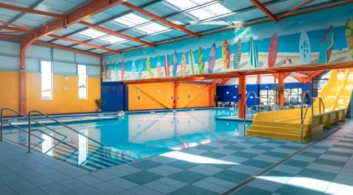 a large swimming pool with a pool slide in it at The Bouys & Gulls Retreat in Parkeston