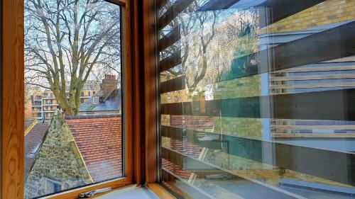 a window with a view of a christmas tree at Superb Guest Room in London