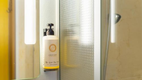 a bottle of soap is sitting in a window at Kyriad ECO - Lorient Lanester in Lanester