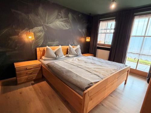 a bedroom with a large bed in a room at Ferienhof Hofmann in Böbrach
