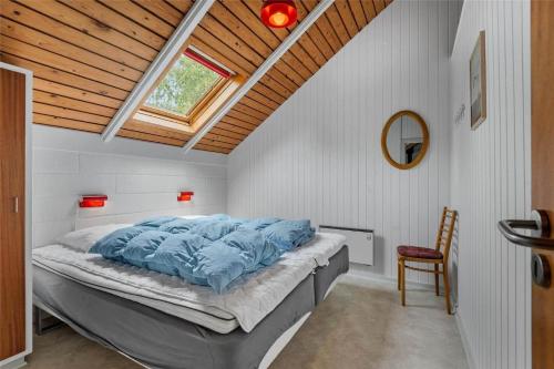 a bedroom with a large bed with a window at 0152-Romo-Ejnar-Mikkelsensvej-5 in Høm