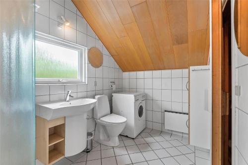 a bathroom with a toilet and a sink at 0152-Romo-Ejnar-Mikkelsensvej-5 in Høm