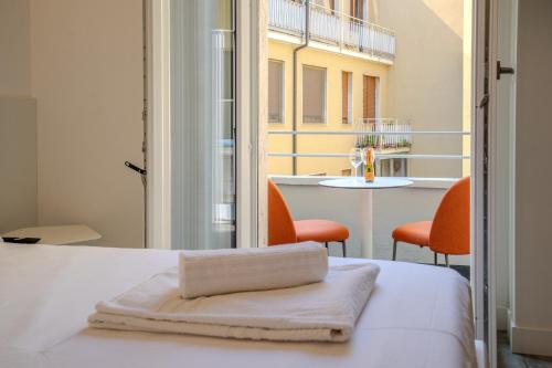 a bedroom with a bed and a table with chairs at Italianflat - Vandom 2 Duomo Luxury Rooms Foresteria Lombarda in Milan