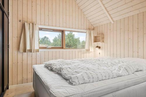 a large white bed in a room with a window at 0212-Romo-Lejrbjergvej-24 in Høm