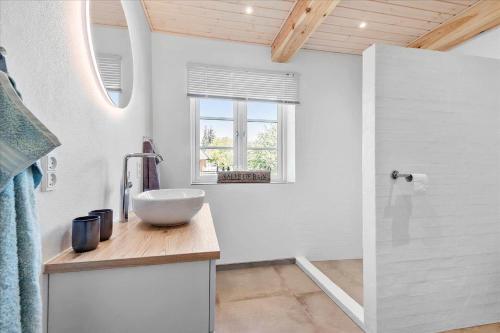 a bathroom with a bowl sink on a counter at 0145-Romo-Hattesvej-36 in Høm