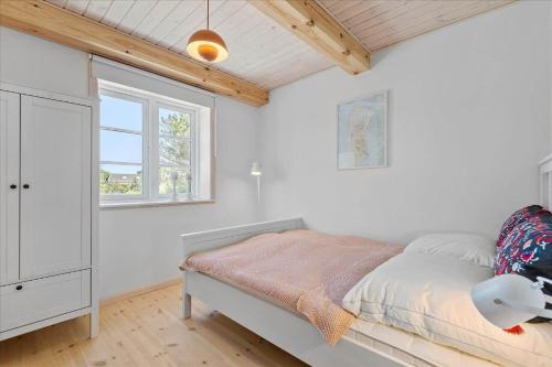 a bedroom with a bed and a window at 0145-Romo-Hattesvej-36 in Høm