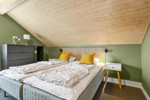 a large bed in a room with a wooden ceiling at 0442-Romo-Vestergade-137-Ap-101 in Høm