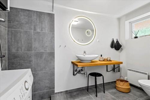 a bathroom with a sink and a mirror at 0172-Romo-Rabjergvej-84 in Høm