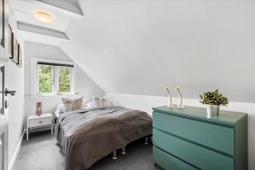 a bedroom with a bed and a blue dresser at 0172-Romo-Rabjergvej-84 in Høm