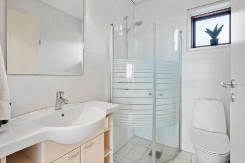 a bathroom with a sink and a shower and a toilet at 0263-Romo-Lyngvejen-99-Ap-28 in Høm