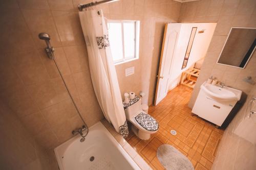 a bathroom with a tub and a toilet and a sink at Vientos San Pedro in San Pedro de Atacama