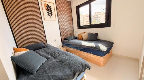 a small bedroom with a bed and a window at Sunny Place Oasis del Sol in Arenales del Sol