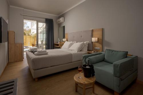 a bedroom with a bed and a couch at Georgioupolis Beach Hotel in Georgioupolis