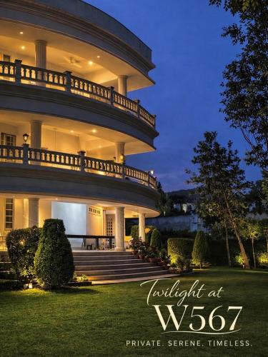 a large building with a staircase in front of it at Boutique Villa w Bonfire & BBQ, Mussoorie Foothills in Dehradun